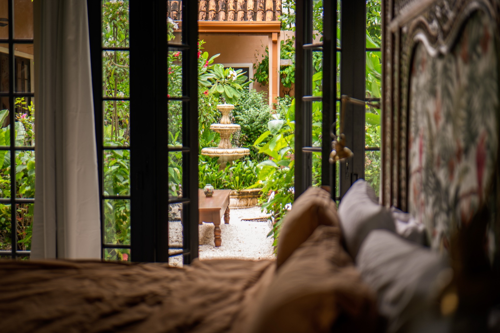 Bedroom view through french doors to courtyard