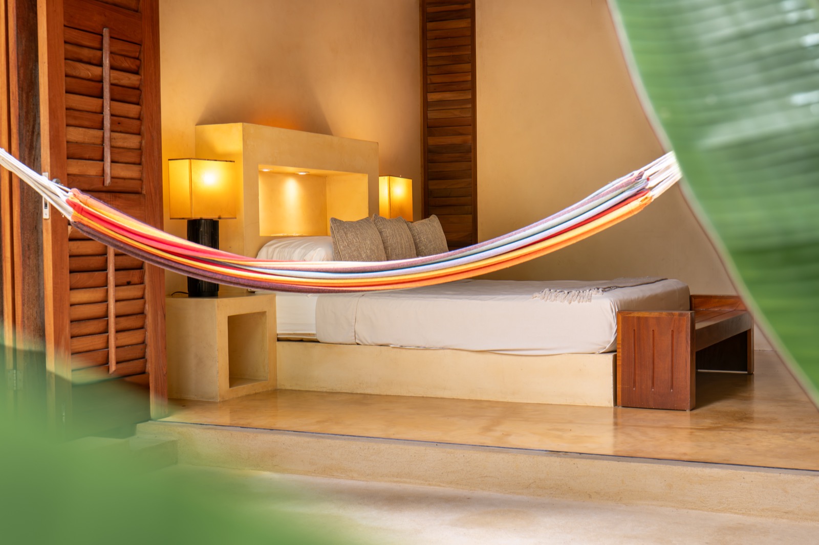 Tropical bedroom with colorful hammock and shutters