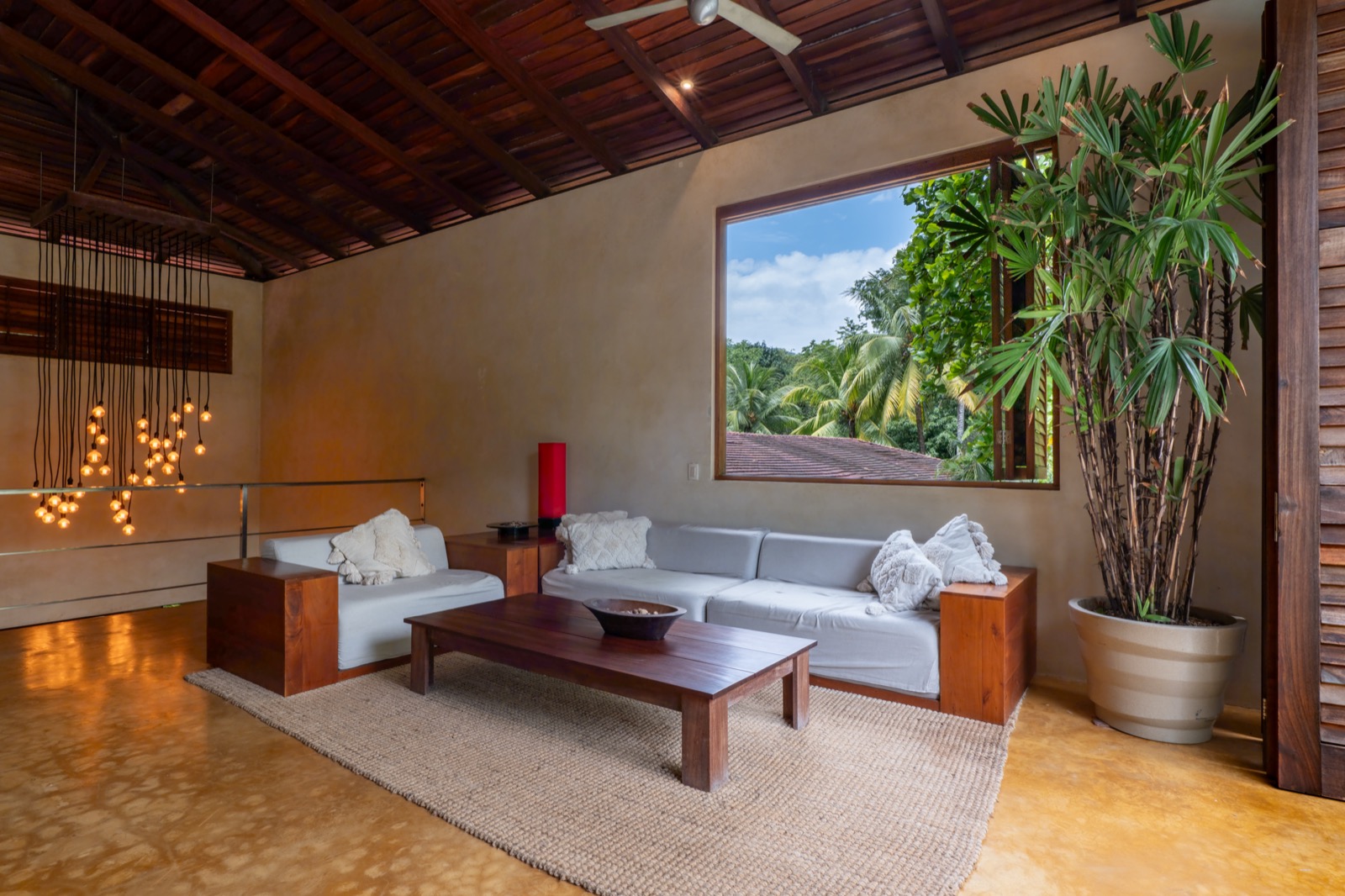 Elegant living room with wood ceiling and tropical view
