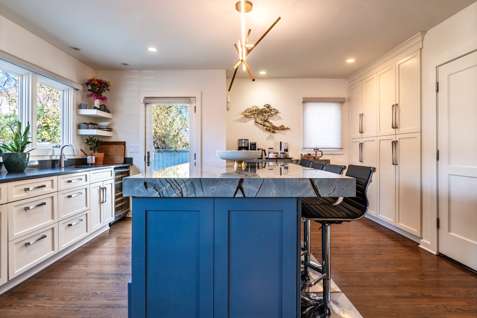 Modern kitchen with blue island and marble countertop